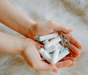 hands holding tampons